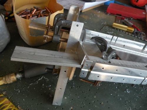 A rather convoluted clamping arrangement to positon the F-711C angle for drilling.
