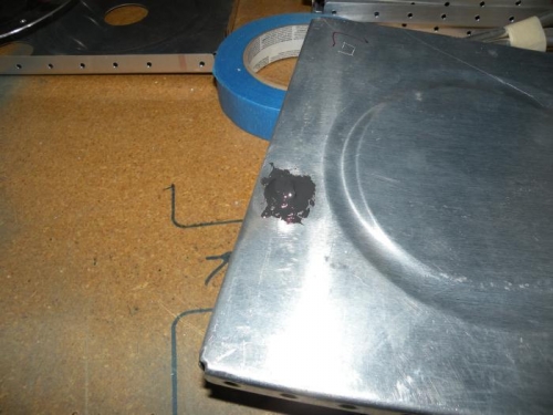 A 3/16 rivet fills the tooling hole at the aft end of the outboard end rib.