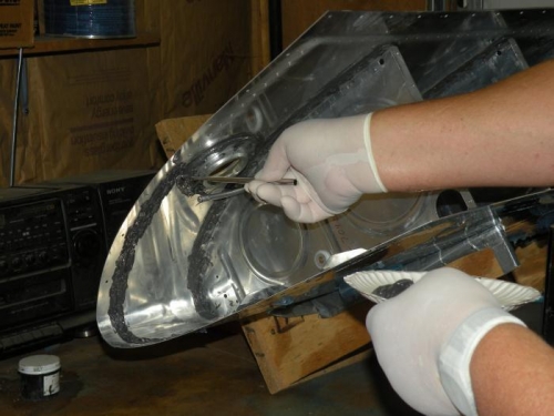 Spreading sealant with a trimmed acid brush.