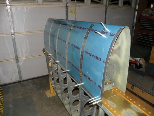 Five most outboard leading edge ribs riveted.
