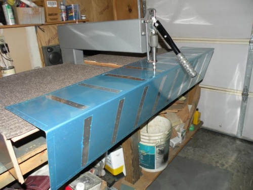 Dimpling stiffener rivet lines in the skin.