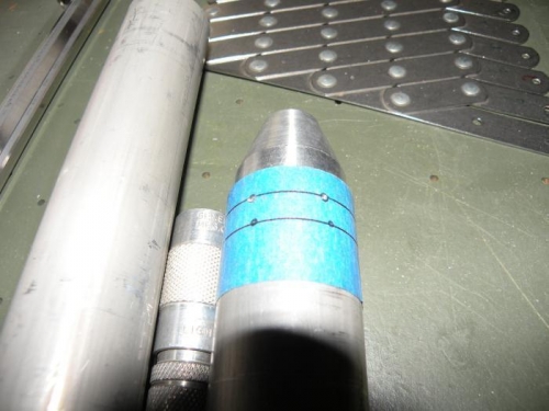 One end of a W-716 push tube marked and center punched for rivet holes.