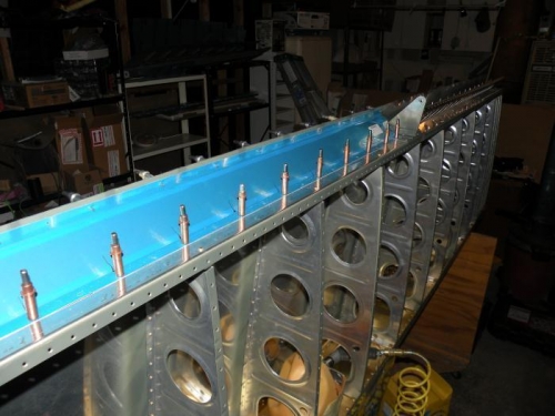 Aileron gap seal and flap brace drilled to left rear spar.