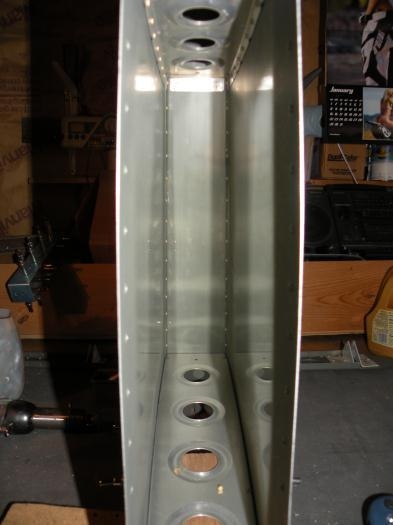 Skin riveted to lower front spar VS-702 and mid rib VS-707.