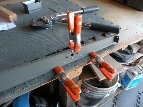 Riveting the hinge reinforcement plates.