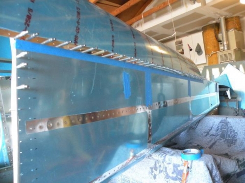 Aft fuselage side skin masked for priming.