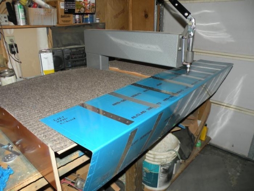 Dimpling the left aileron skin.