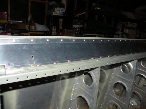 Squeezed the skin rivets; shot and bucked the spar rivets.