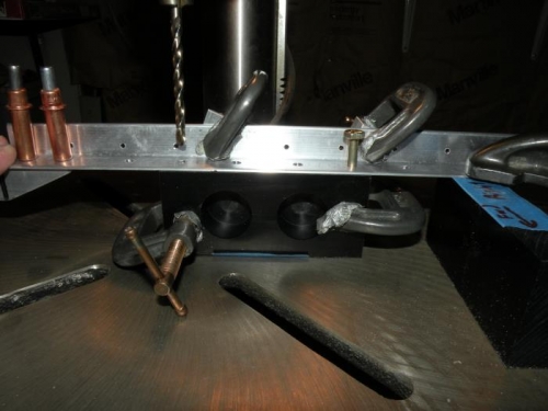 Setup for backdrilling the bearing blocks through the forward skin stiffener.