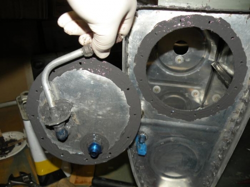 Return line fitting installed, and sealant applied to cover and rib.