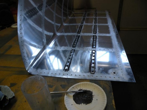 Stiffeners riveted, filleted, and rivets encapsulated.