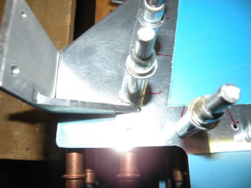 Skin trimmed back to fwd edge of rib flange. Rudder brace drilled and clecoed.