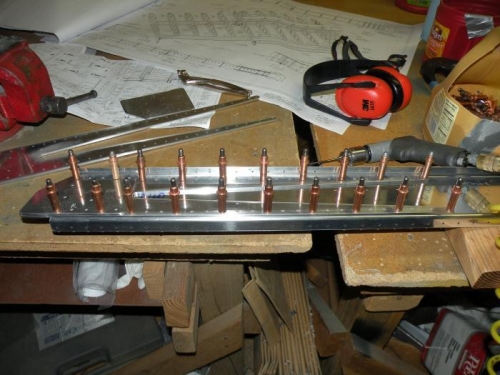 Reinforcement fork and rear spar doubler plate clecoed to right spar channel and ready  to match ream.