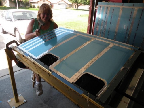 Inboard skin riveting complete.  I HOPE Karen is just teasing with the hammer...
