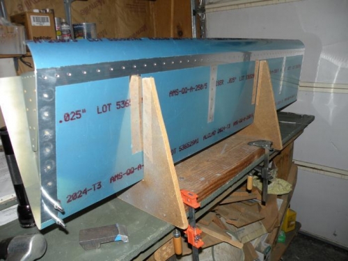 Top side of skin riveted to rib flanges.