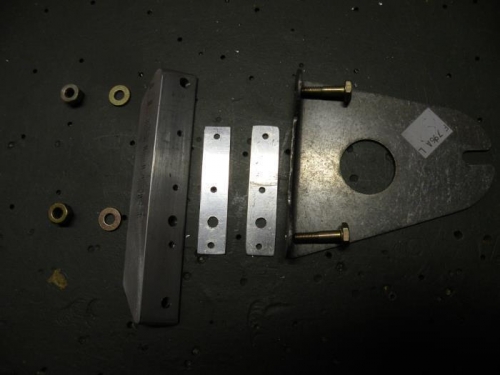 All of the parts required for installing the left fuel tank attach bracket.