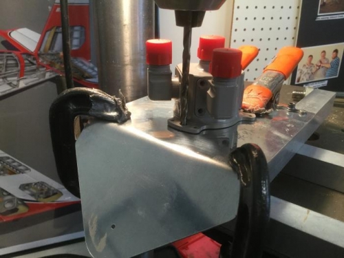 Setup to drill the first hole for attaching the fuel valve to the cover plate.