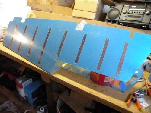 Vinyl removed from stiffener rivet lines on the left elevator skin.