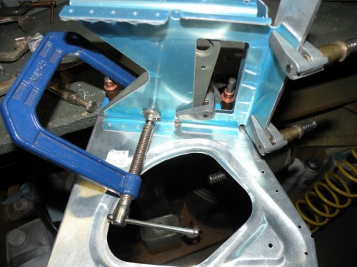 The forward bracket aligned and clamped for drilling.