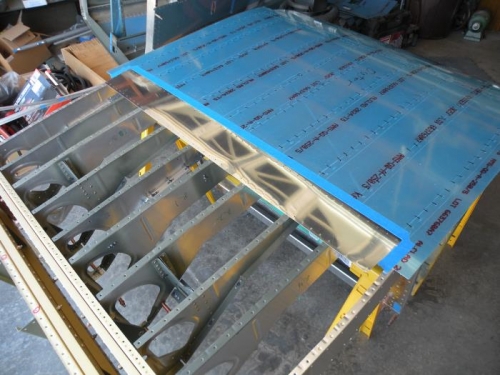 Underlapping section of the forward bottom skin masked off for scuffing, cleaning, and priming.