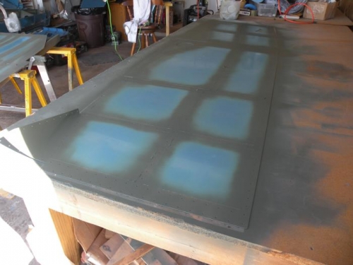 Interior surfaces of the right forward side skin devinyled, deburred, scuffed, cleaned, and primed.