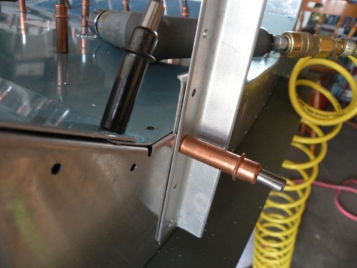 Positioning the rib flange for drilling through the seat pans.