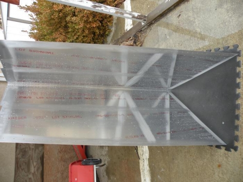 The water sheeting off of the scuffed surfaces indicates adequate cleaning for primer adhesion.