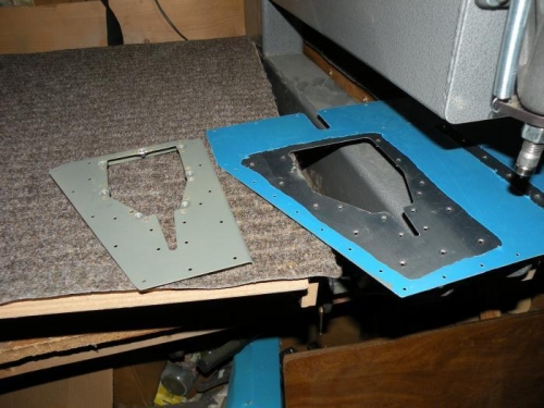 Nutplates installed on reinforcement plate, skin dimpled.