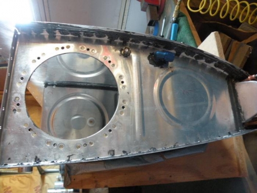 Left tank inboard end rib riveted and shop heads encapsulated.