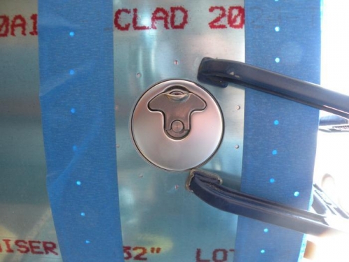 Left fuel cap taped and clamped in place for drilling.