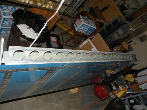 Flap brace riveted to rear spar.