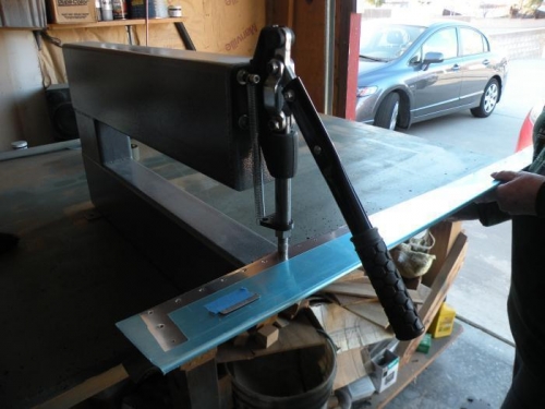 Dimpling the bottom row of rivet holes in the top skin.