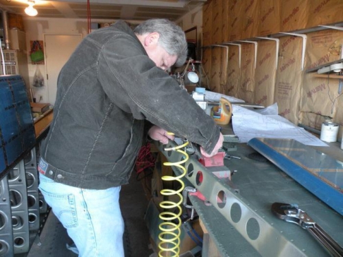 Dimpling the top flange of the main spar.