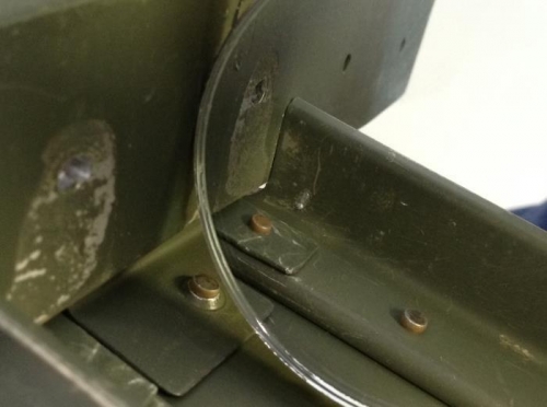 Closeup of the inside of the right main longeron showing the shop head of the top skin rivet.