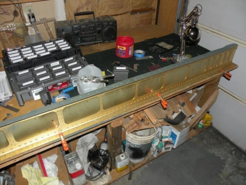 Right lower spar flange primed and nutplates riveted.