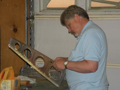 Deburring conduit holes.