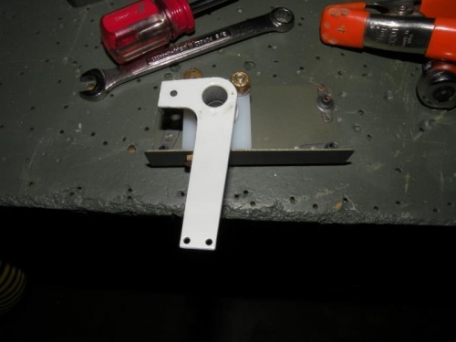The aileron trim bearing block and arm installed in the bracket.