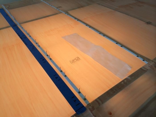 Two rows with tape and rivets. Lit from below.