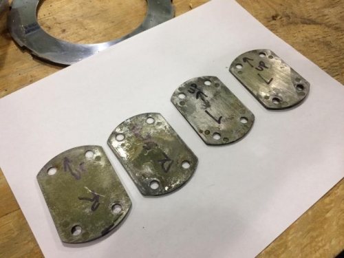 Shims - two each side, thin part up.