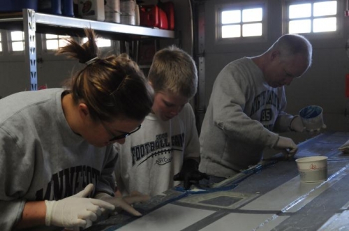 Mandy, Anders and Jim all busy spreading thin layer of Hysol on the wing skin