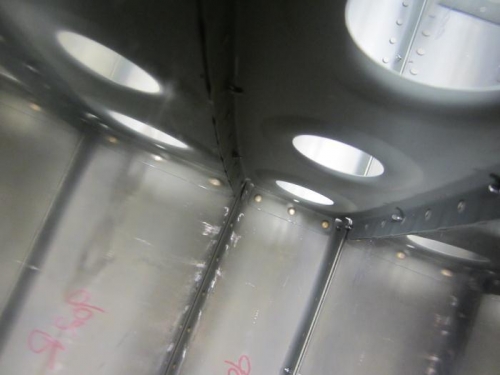 Bent tab with rivet (notice gap)