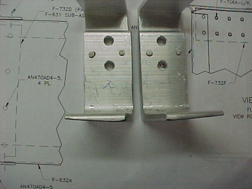 The mounting angles are tapered to accomodate the shape of the rear upper skin