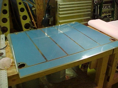 The front bottom skin showing the blue plastic protector removed at the rivet lines.