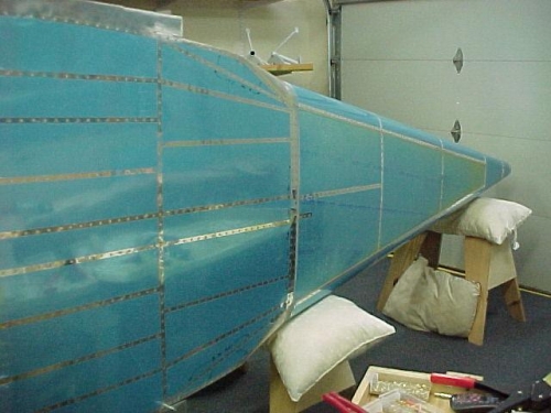 The fuselage on its side with the bottom all riveted