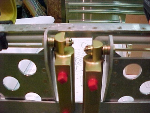 Master cylinders bolted to brake pedals.