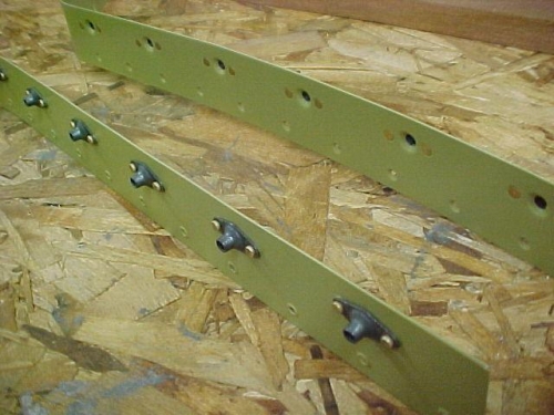 Splicer strips primed and platenuts riveted in place