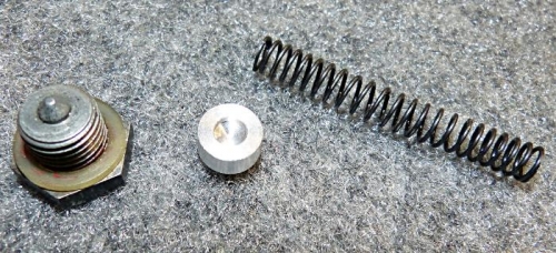 Oil pressure relief spring spacer