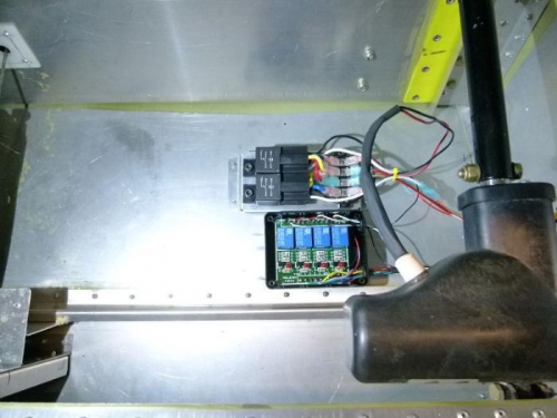 Trim and flap controlsw relays mounted  behind pilot seat