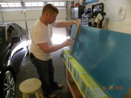 Me removing protective coating along rivet holes