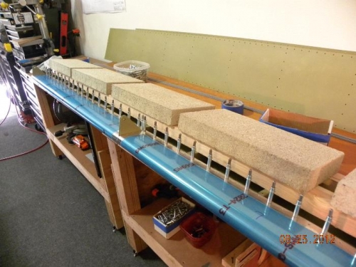 Flap weighted down to straighten it for riveting the nose ribs